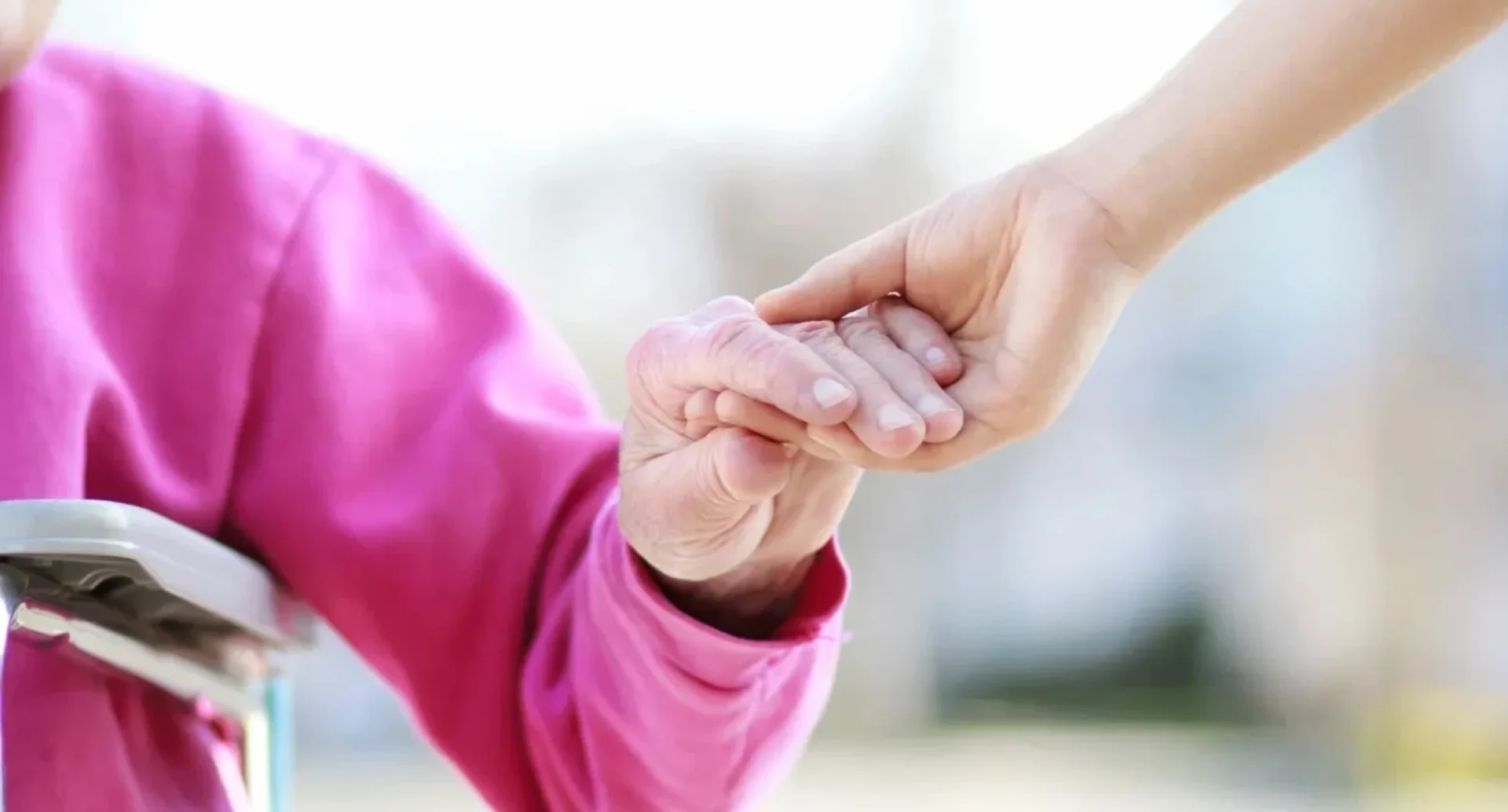 A person holding another persons hand in their hands.